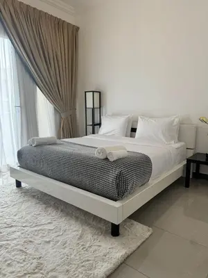 a bed with two towels on it in a bedroom at Swarg Stay in heart of Dubai in JVC in Dubai