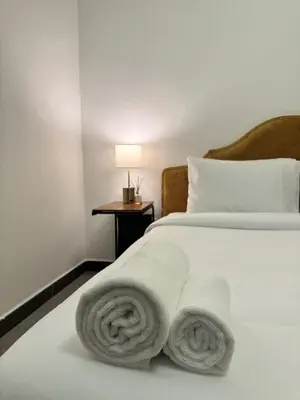 a bedroom with a bed with towels on it at Swarg Stay in heart of Dubai in JVC in Dubai