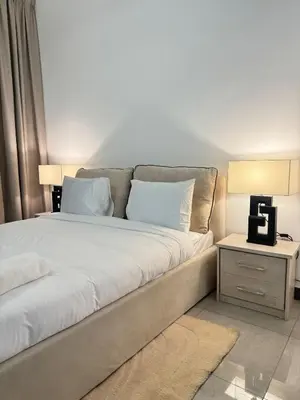 a bedroom with a large bed with white pillows at Swarg Stay in heart of Dubai in JVC in Dubai