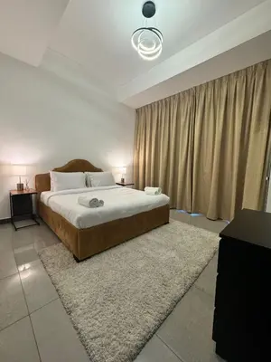 a bedroom with a large bed with a rug at Swarg Stay in heart of Dubai in JVC in Dubai