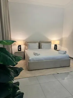 a bedroom with a bed and a plant at Swarg Stay in heart of Dubai in JVC in Dubai