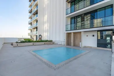a swimming pool in the middle of a building at Elegant 1BR Apt in JVC Dubai with Spacious Balcony & City Views in Dubai
