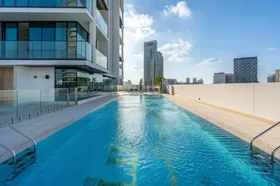a swimming pool on the side of a building at Elegant 1BR Apt in JVC Dubai with Spacious Balcony & City Views in Dubai