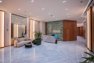 a lobby with a couch and chairs in a building at Elegant 1BR Apt in JVC Dubai with Spacious Balcony & City Views in Dubai