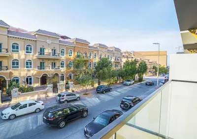 a view of a city street with cars parked on the street at Spacious 3BR Apartment in JVC Dubai Modern & Cozy Stay in Dubai