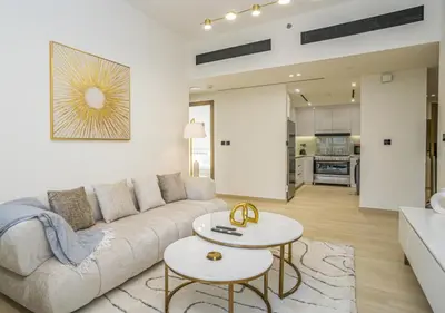 a living room with a couch and a table at Spacious 3BR Apartment in JVC Dubai Modern & Cozy Stay in Dubai