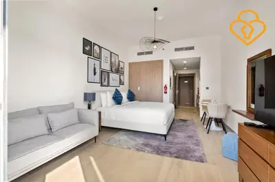 a living room with a white bed and a couch at Keysplease Studio Azizi Riviera Near Downtown, Meydan One in Dubai