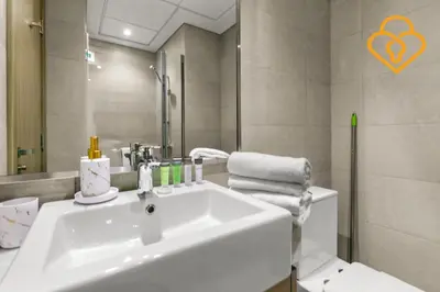 a bathroom with a white sink and a mirror at Keysplease Studio Azizi Riviera Near Downtown, Meydan One in Dubai