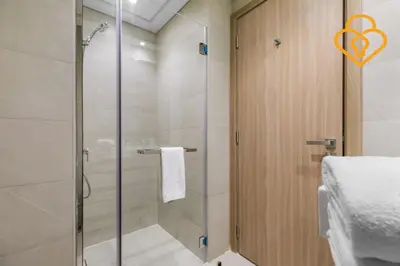 a shower with a glass door in a bathroom at Keysplease Studio Azizi Riviera Near Downtown, Meydan One in Dubai