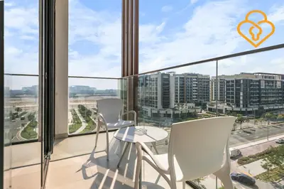 a balcony with white chairs and a view of a city at Keysplease Studio Azizi Riviera Near Downtown, Meydan One in Dubai