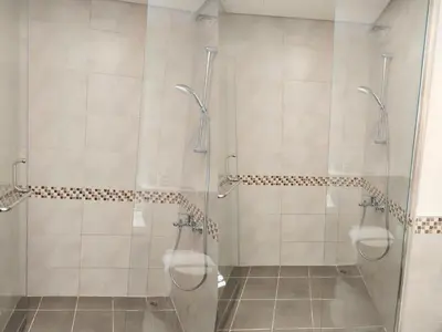 a bathroom with two urinals in a shower at Burj View 2BR Near Dubai Mall Fast Wi-Fi Balcony in Dubai