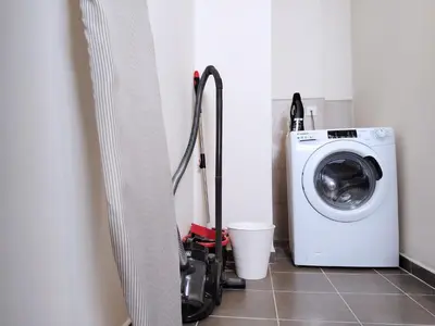 a laundry room with a washer and a washing machine at Burj View 2BR Near Dubai Mall Fast Wi-Fi Balcony in Dubai
