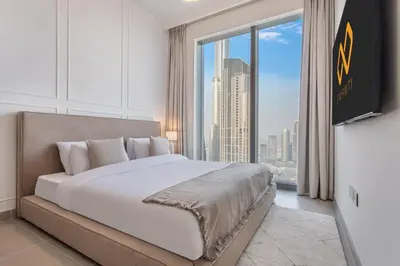 a bedroom with a large bed and a large window at High Floor Apartment with full Burj Khalifa View, Opera & Fountain - Downtown Dubai - Forte Tower by Stayfinity in Dubai