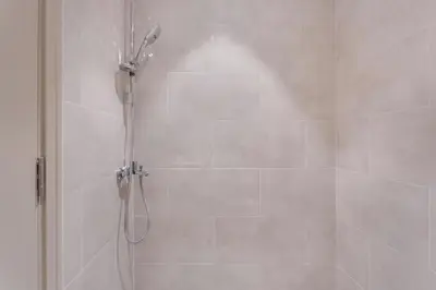 a shower with a shower head in a bathroom at High Floor Apartment with full Burj Khalifa View, Opera & Fountain - Downtown Dubai - Forte Tower by Stayfinity in Dubai