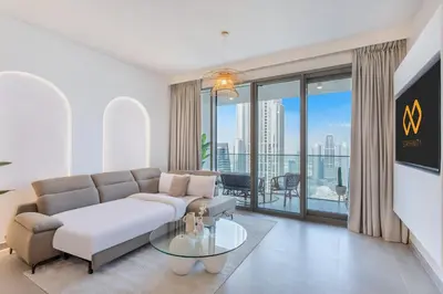 a living room with a couch and a glass table at High Floor Apartment with full Burj Khalifa View, Opera & Fountain - Downtown Dubai - Forte Tower by Stayfinity in Dubai