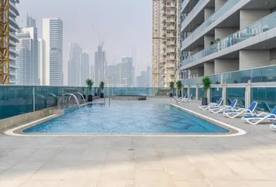 a swimming pool on the roof of a building at High Floor - Bright Elite Studio in Business Bay in Dubai