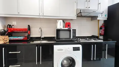 a kitchen with a sink and a washing machine at High Floor - Bright Elite Studio in Business Bay in Dubai