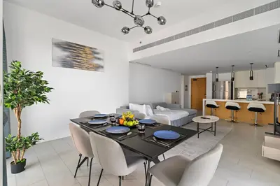 a living room with a table and chairs and a couch at Spacious Dubai Marina 2BR Great Views Top Location in Dubai