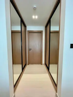 a hallway with mirrors and a wooden door at Brand New Cozy 2br Apartment In Jvc With Balcony in Dubai