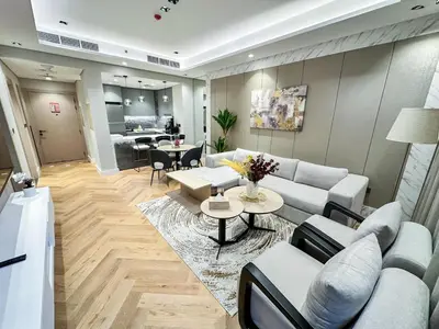 a living room with a couch and a table at Vserve 1 BR Stay with Stunning Skyline Views in Dubai