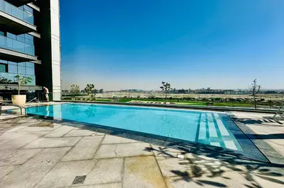 a swimming pool on the side of a building at Vserve 1 BR Stay with Stunning Skyline Views in Dubai