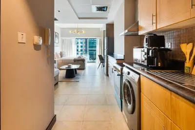 a kitchen with a washer and dryer at Stylish JLT Studio Lake View PoolMarina Walk in Dubai