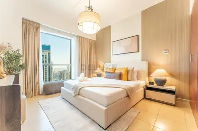 a bedroom with a large white bed and a large window at Close to Major Landmarks 3BR and Assistant Room with Marina Views, Rimal 5, JBR by Deluxe Holiday Homes in Dubai