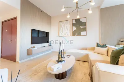 a living room with a couch and a table at Close to Major Landmarks 3BR and Assistant Room with Marina Views, Rimal 5, JBR by Deluxe Holiday Homes in Dubai