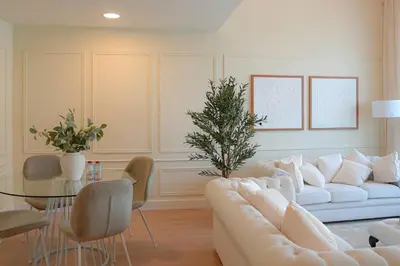 a living room with a white couch and a glass table at Luxe JLT 1BR Apt Gym Pool & Stunning Views in Dubai