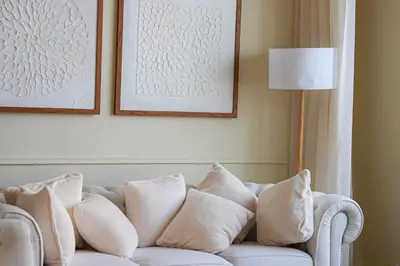 a white couch with pillows in a living room at Luxe JLT 1BR Apt Gym Pool & Stunning Views in Dubai