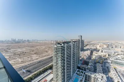 an aerial view of a city with a tall building at City Views 1BR Near Community Park with Private Balcony, Binghatti House, Jumeirah Village Circle by Deluxe Holiday Homes in Dubai