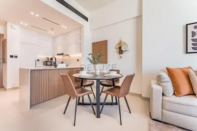 a kitchen and dining room with a table and chairs at City Views 1BR Near Community Park with Private Balcony, Binghatti House, Jumeirah Village Circle by Deluxe Holiday Homes in Dubai