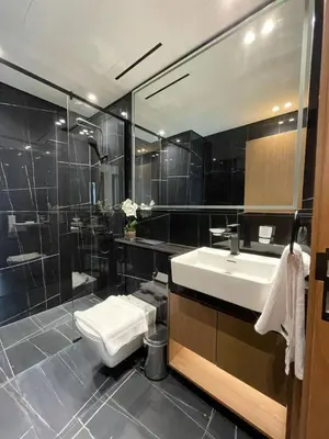 a bathroom with a sink and a toilet and a shower at Premium 2br Apartment With Private Pool In Jvc in Dubai