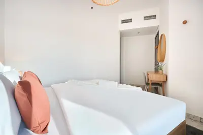 a white bedroom with a bed and a mirror at Family-Friendly 2BR Apartment in Dubai South at MAG-565 near EXPO and Al Maktoum Airport DWC in Dubai