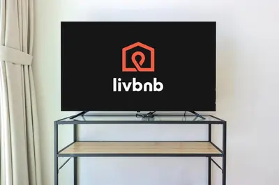 a flat screen tv sitting on a tv stand at Livbnb-Urban Getaway 1BHK with JVC Skyline View in Dubai