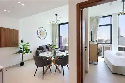 a bedroom and living room with a table and chairs and a bed at Livbnb-Urban Getaway 1BHK with JVC Skyline View in Dubai