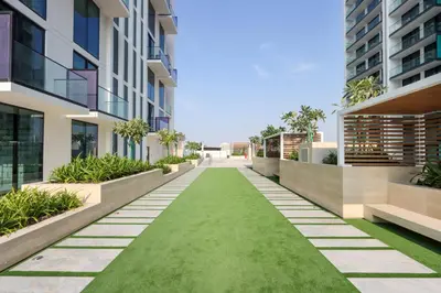 an internal courtyard of an apartment building with a green lawn at Livbnb-Urban Getaway 1BHK with JVC Skyline View in Dubai