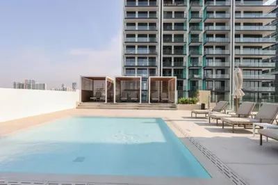 a swimming pool on the roof of a building at Livbnb-Urban Getaway 1BHK with JVC Skyline View in Dubai