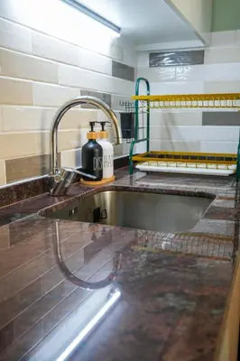 a kitchen with a sink with a toaster on the counter at Your comfy stylish studio in Dubai 2guest and baby in Dubai