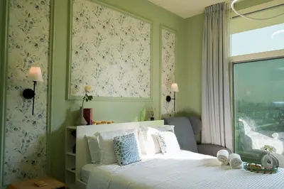 a bedroom with a white bed with a window at Your comfy stylish studio in Dubai 2guest and baby in Dubai