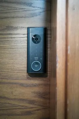 a black remote control on a wooden door at Your comfy stylish studio in Dubai 2guest and baby in Dubai