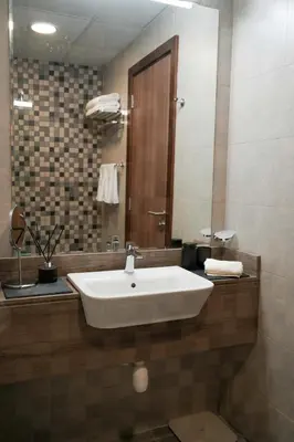 a bathroom with a white sink and a mirror at Your comfy stylish studio in Dubai 2guest and baby in Dubai
