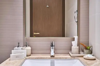 a bathroom with a sink and a mirror at Luxury 2BR Apartment in Grand Bleu Tower at EMAAR Beachfront - High Floor with Marina and City View, Private Beach Access by Stayfinity in Dubai