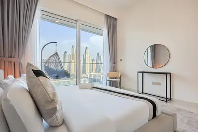 a bedroom with a bed and a large window at Luxury 2BR Apartment in Grand Bleu Tower at EMAAR Beachfront - High Floor with Marina and City View, Private Beach Access by Stayfinity in Dubai
