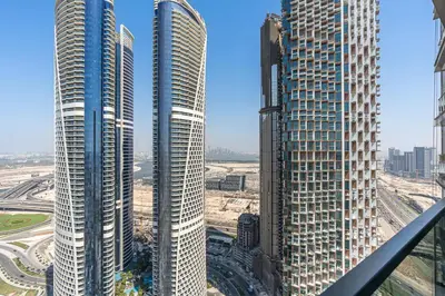 two tall skyscrapers in a city next to each other at Stylish New Apt, Minutes from Downtown Dubai in Dubai