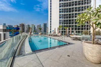a swimming pool on the roof of a building at Stylish New Apt, Minutes from Downtown Dubai in Dubai