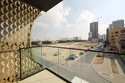 a view of a city from a glass balcony at Modern 2 bedroom in Binghatti Crescent JVC- Truebleu vacation homes in Dubai