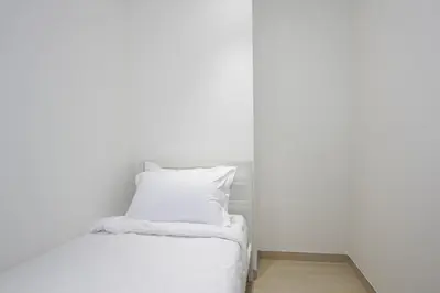 a bed with white sheets and a pillow at Modern 2 bedroom in Binghatti Crescent JVC- Truebleu vacation homes in Dubai