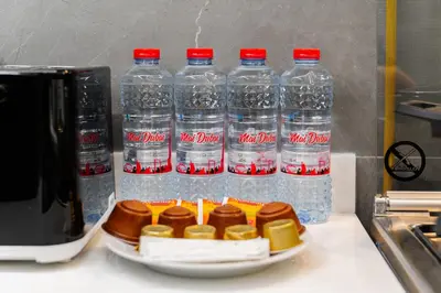 a group of bottles of water sitting on top of a counter at SettlerHomes - Elegant JLT Lakefront Near Metro in Dubai