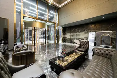 a lobby with couches and a table and chairs at SettlerHomes - Elegant JLT Lakefront Near Metro in Dubai
